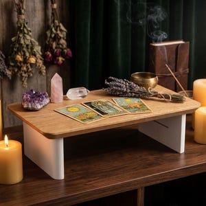 a wooden altar with candles, crystals, tarot cards, and dried flowers, creating a serene and spiritual atmosphere.
