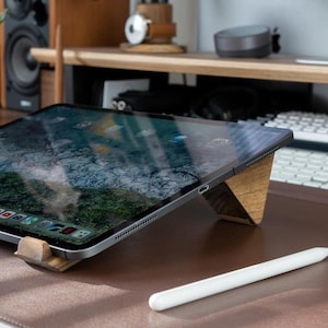 a tablet sitting on top of a wooden desk