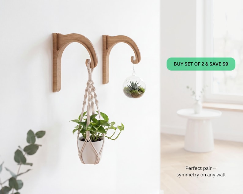 a set of two wooden wall-mounted planters with hanging plants, displayed in a room with a white wall and a window.