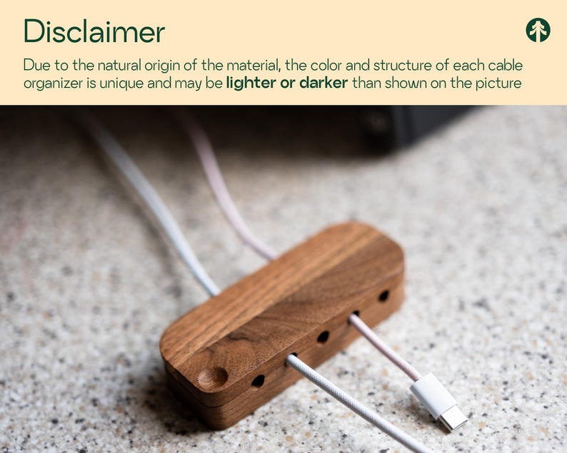 a wooden cable organizer with multiple white cables plugged into it, placed on a speckled surface.