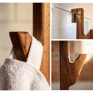 a wooden towel rack with a white towel hanging on it. The towel rack is made of wood and has a glass panel at the top. The image is a collage of three close-up shots, showing different aspects of the wooden towel rack.