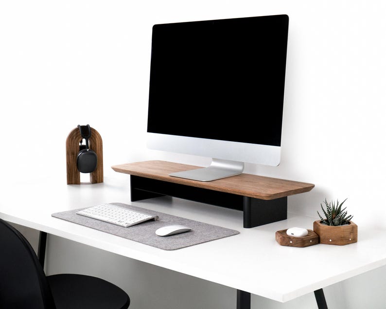 a desk with a computer monitor, keyboard and mouse
