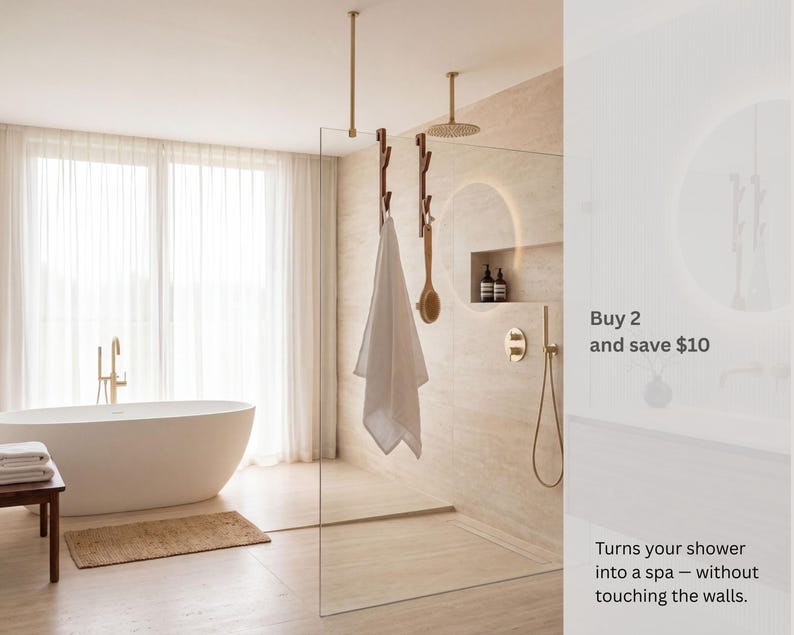 a modern bathroom with a large bathtub, a shower enclosure, and a towel rack. The bathroom has a minimalist and clean design, with a neutral color scheme.
