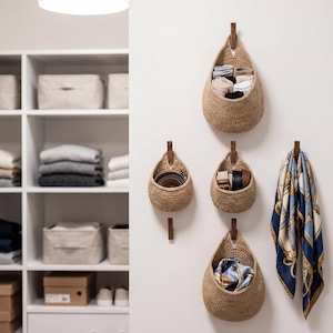 A well-organized closet with various storage solutions, including woven baskets and shelves, neatly arranged with folded clothes and accessories.