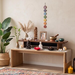 a serene and well-decorated room with a wooden bench, a variety of plants, and an array of decorative items.