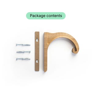 a wooden hook or hanger with three screws and a wooden bar, along with a green text box that reads "Package contents".