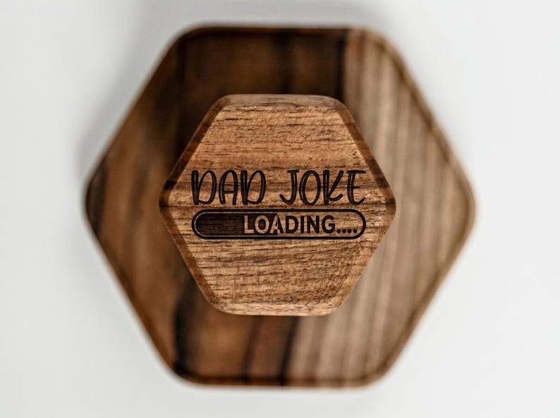 A wooden object with the text "DAD JOKE LOADING..." printed on it.