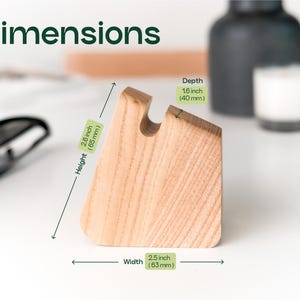 a wooden object, possibly a piece of furniture or a tool, with dimensions and a label indicating its height, width, and depth.