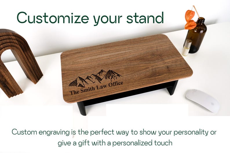 a wooden stand with a mountain design engraved on it, along with a wooden sculpture and a glass bottle. The text overlay encourages custom engraving as a way to showcase one's personality or give a personalized gift.