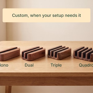 four wooden charging docks of different types, labeled as "Mono", "Dual", "Triple", and "Quadro", arranged on a wooden table.