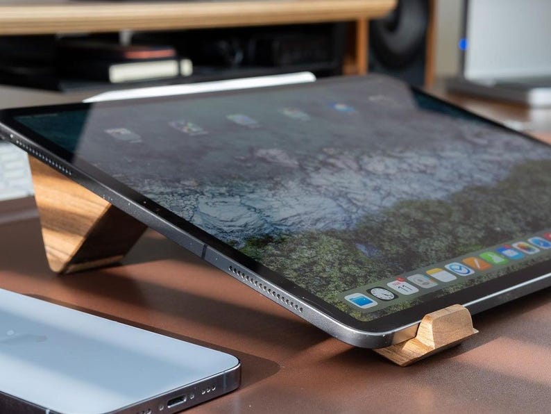 a tablet sitting on top of a wooden table