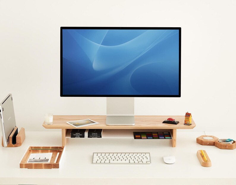 a computer monitor sitting on top of a white desk