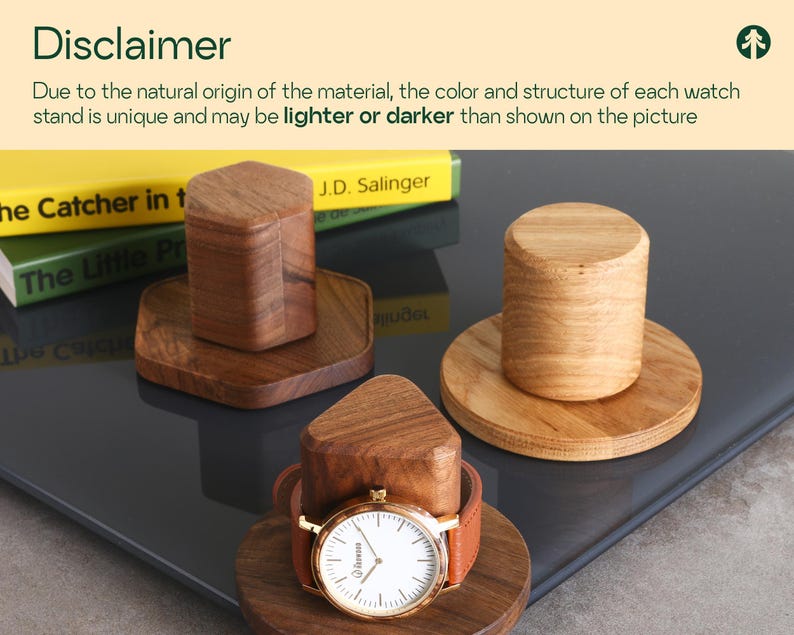 a wooden watch stand with a wooden watch placed on top of it, along with a book titled "The Catcher in the Rye" by J.D. Salinger.