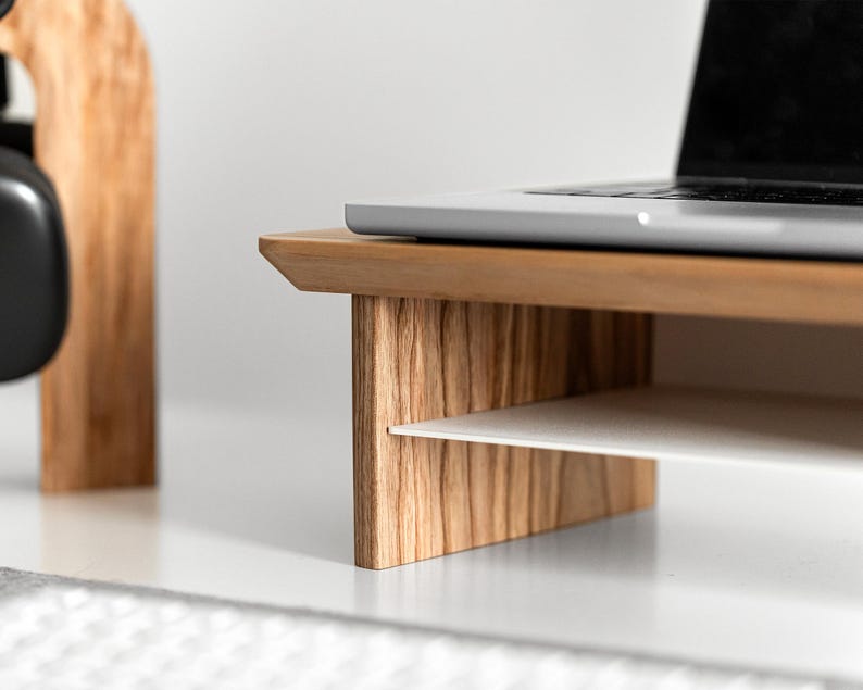 a laptop computer sitting on top of a wooden desk