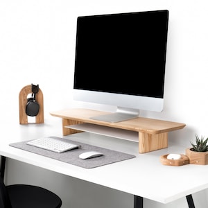 a computer monitor sitting on top of a white desk