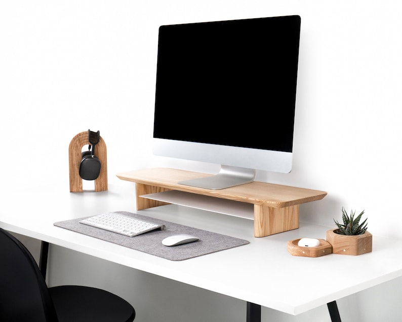 a computer monitor sitting on top of a white desk