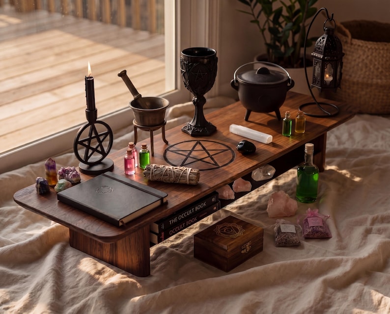 a wooden table with various items related to spells and rituals, including a cauldron, a crystal ball, a pentagram, and a book titled "The Occult Book".
