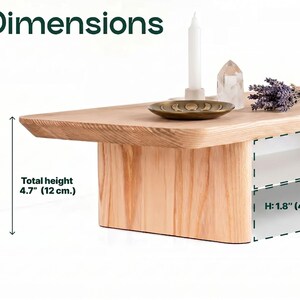 a wooden coffee table with a candle, a crystal, and a bouquet of lavender flowers on it. The table has a total height of 4.7 inches (12 centimeters).