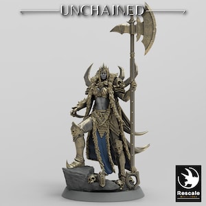May include: A gold-painted miniature figurine of a female warrior with a horned helmet, wearing armor and a fur cloak, holding a large axe. The figurine is standing on a rocky base with skulls.