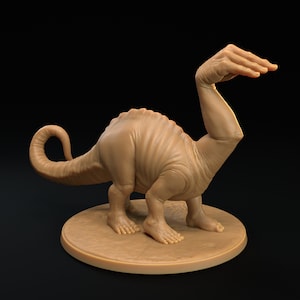 May include: A brown, sculpted figurine of a dinosaur with a human arm for a neck. The dinosaur is standing on a round base.