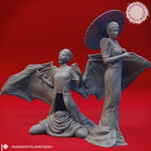 May include: Two gray painted figurines of women. One woman is wearing a traditional dress and holding an umbrella. The other woman is wearing a similar dress and has bat wings. The figurines are on a red background.
