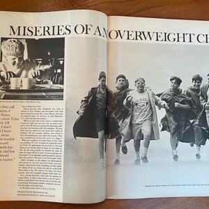 May include: A black and white magazine spread titled MISERIES OF AN OVERWEIGHT CHILD. The left page features a photograph of a child eating and a column of text. The right page shows a group of children running outdoors in rain gear.
