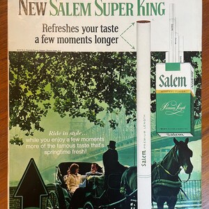 May include: A vintage advertisement for New Salem Super King cigarettes featuring a green-toned illustration of a horse-drawn carriage on a bridge. The text reads: Try the one menthol taste worth making longer! New Salem Super King. Refreshes your taste a few moments longer. Ride in style... while you enjoy a few moments more of the famous taste that's springtime fresh!