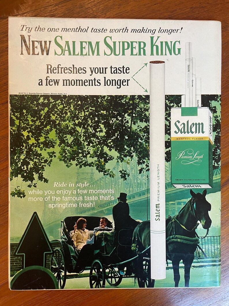May include: A vintage advertisement for New Salem Super King cigarettes featuring a green-toned illustration of a horse-drawn carriage on a bridge. The text reads: Try the one menthol taste worth making longer! New Salem Super King. Refreshes your taste a few moments longer. Ride in style... while you enjoy a few moments more of the famous taste that's springtime fresh!