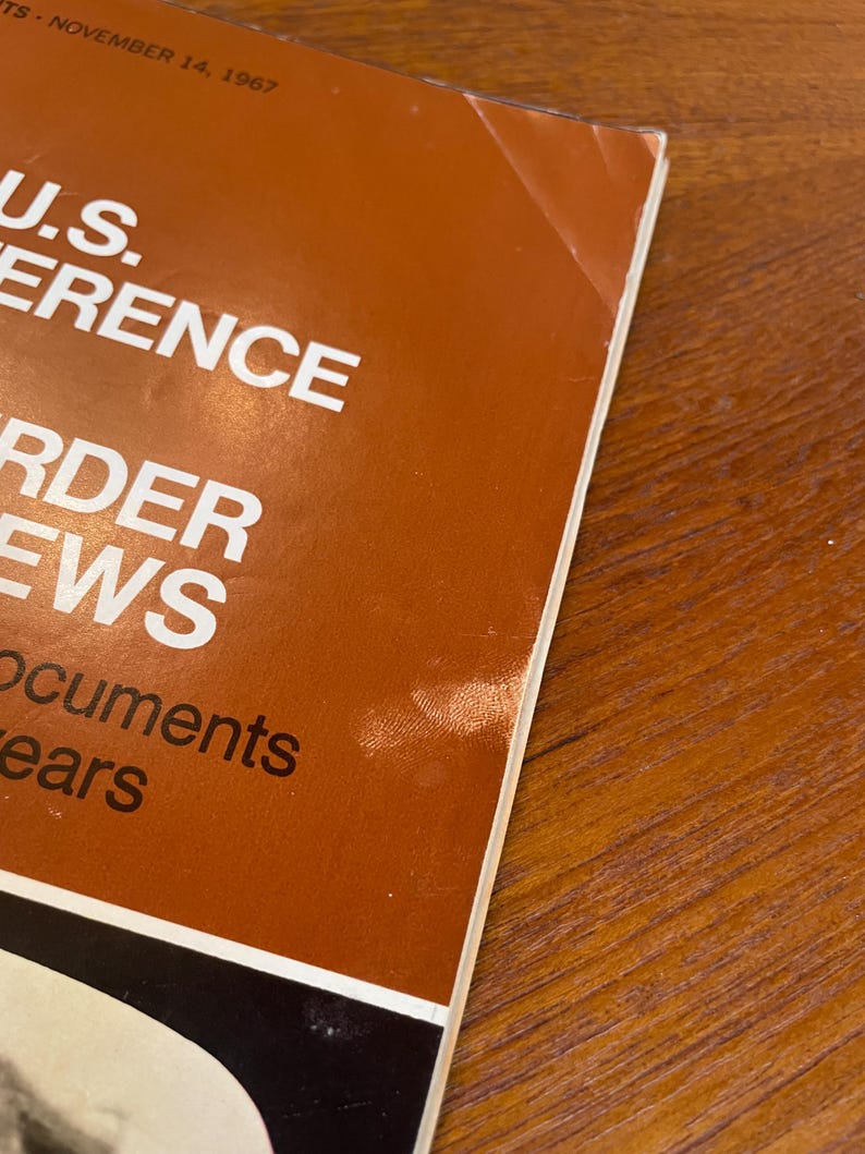 May include: A vintage magazine cover with a brown background and white text reading U.S. CONFERENCE, ORDER, NEWS, and documents years. The date NOVEMBER 14, 1967 is printed at the top. The paper shows signs of wear with a small crease on the top right corner.