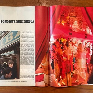 May include: A vintage magazine spread titled BIBA: LONDON'S MINI MECCA. The left page features a black and white photograph of the Biba storefront. The right page displays a vibrant, red-toned photograph of people in a crowded, dimly lit interior.