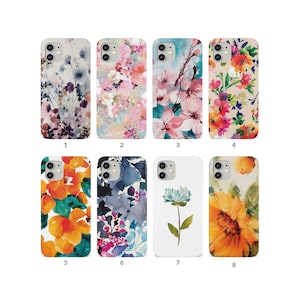 May include: A collection of eight phone cases with floral designs. The cases feature various watercolor-style flower patterns in shades of pink, orange, blue, and purple. Each case has a different design, showcasing a variety of floral arrangements.