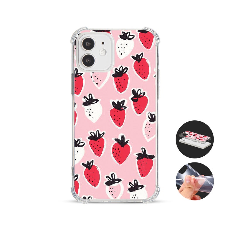 May include: Transparent phone case featuring a pink backdrop adorned with red and white strawberry motifs. The case has a protective bumper. A cheerful and playful accessory for a mobile phone, offering both style and protection.