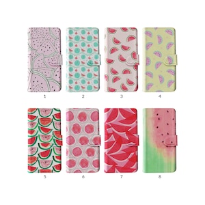 May include: A collection of eight phone cases with watermelon-themed designs. The cases feature various patterns of watermelon slices and whole watermelons in shades of pink, red, green, and yellow. Each case has a magnetic closure.
