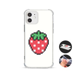 May include: Clear phone case featuring a pixelated strawberry design. The red strawberry has green leaves and white seeds. The case is shown on a white background with a close-up of the case and a hand holding the case.