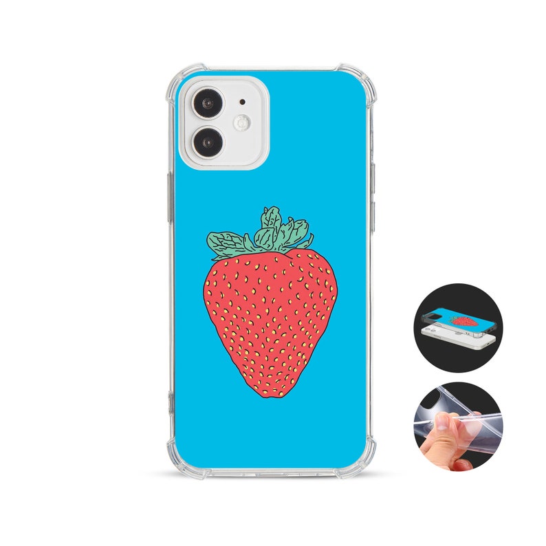 May include: A clear phone case featuring a large red strawberry illustration on a bright blue backdrop. The strawberry has green leaves and a textured surface. The case is designed to protect the phone while displaying the colourful design.