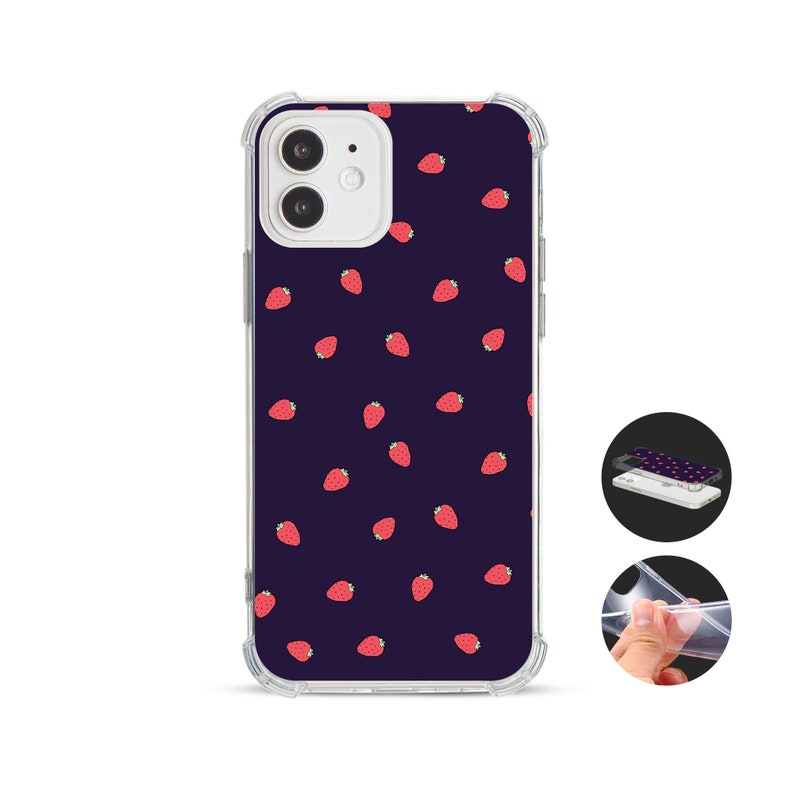 May include: Clear phone case featuring a dark blue background adorned with a pattern of red strawberries. The case has a protective bumper and is designed for a smartphone. The image also shows a close-up of the case's design and a person holding the case.