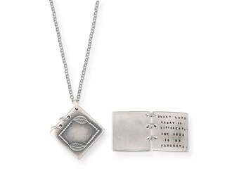 May include: Silver necklace with a small, square pendant that opens to reveal the words "Every love story is different... but ours is my favorite."