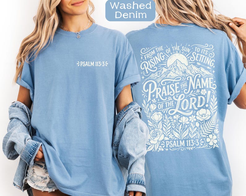 May include: Light blue t-shirt with the text "PSALM 113:3" on the front. The back of the shirt features the phrase "Praise the Name of the Lord!" with floral and mountain illustrations. The shirt is made of a soft material.