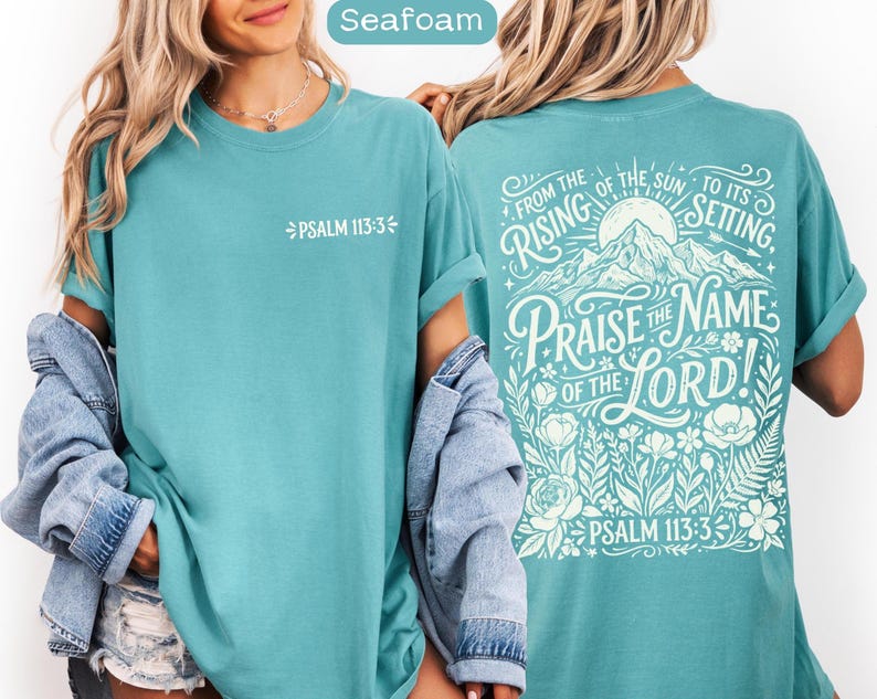 May include: Seafoam-colored t-shirt with the text "PSALM 113:3" on the front. The back of the shirt features a mountain and floral design with the words "FROM THE RISING OF THE SUN TO ITS SETTING, PRAISE THE NAME OF THE LORD!" and "PSALM 113:3".
