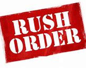 May include: A red rectangular stamp with the white text "RUSH ORDER". The stamp has a distressed, textured appearance, suggesting it has been used multiple times. The text is in a bold, sans-serif font.