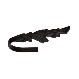May include: Black metal leaf-shaped curtain rod holder with a curved hook and two holes for mounting.
