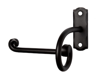 May include: A matte black metal wall-mounted toilet paper holder featuring a rectangular backplate with two screw holes and a curved, scroll-ended arm. The design includes a circular loop support and a horizontal bar with a curled end tip.