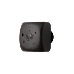 May include: Black square cabinet knob with a rounded edge and a small round knob on the side.