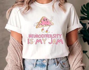 May include: White t-shirt with a pink cartoon sandwich with a face and the text "Neurodiversity is my jam".