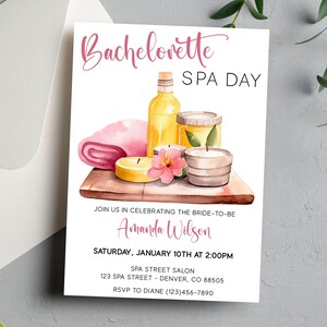 May include: A watercolour illustration of a spa day invitation featuring a pink towel, candles, and bottles of oil. The text reads "Bachelorette Spa Day" and includes the bride-to-be's name, Amanda Wilson, the date, time, and location of the event.