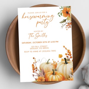May include: A housewarming party invitation with a fall theme. The invitation features a watercolor illustration of pumpkins, leaves, and berries in shades of orange, yellow, and brown. The text on the invitation reads "Please join us for a housewarming party", "Hosted by The Smiths", "Saturday, October 10th at 6:00 PM", "123 Fall Street, Denver, CO 88505", and "RSVP to Anne at (123)456-7890".