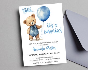 May include: Baby shower invitation featuring a watercolor illustration of a teddy bear holding a blue balloon. The invitation text reads "Shhh... it's a surprise!" and includes event details. A matching envelope is visible.