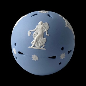 May include: A spherical light blue ceramic object featuring white relief figures of classical individuals in motion, interspersed with small white floral motifs and several cut-out openings across the surface of the rounded form.