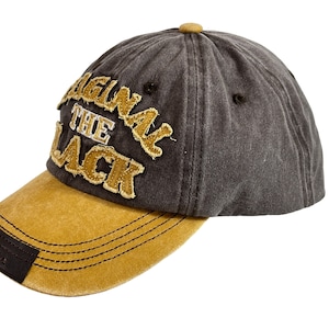 May include: A grey and brown baseball cap with the text "Original The Black" embroidered on the front.