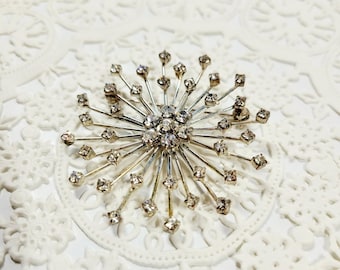 Broche vintage romano RMN firmado, estrella atómica con diamantes de imitación, tono plateado